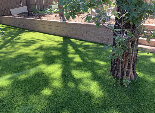 seating space with paver walkways and artificial turf