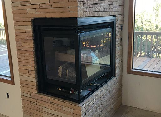 fireplace built into a hand-crafted stone wall