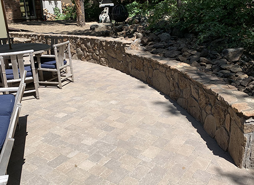 outdoor seating space with curving stone wall boundary