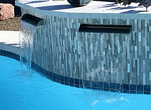 modern geometric water wall into a backyard pool